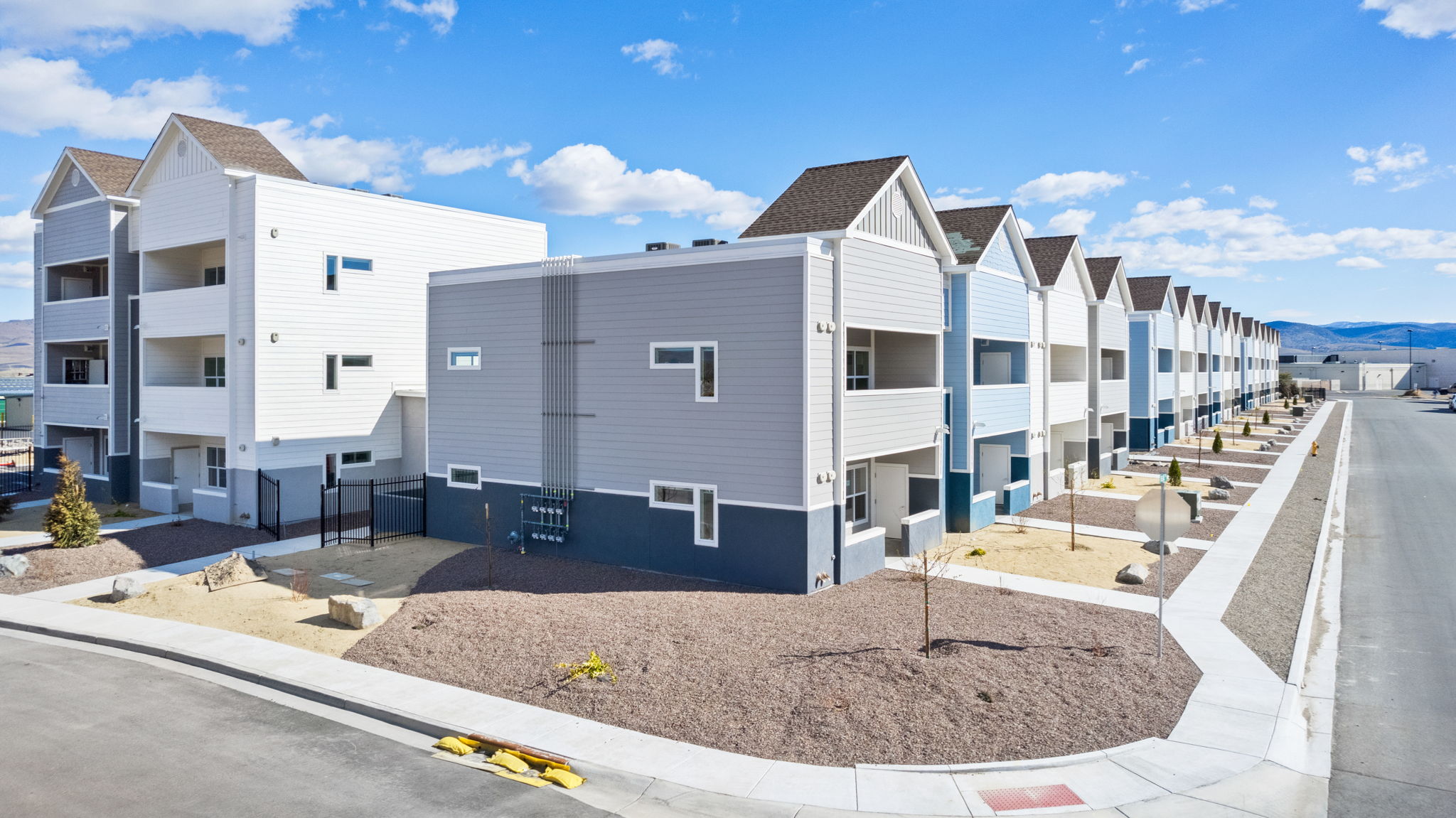 Dayton Gold Country Estates apartment complex exterior view with mountains in the background.